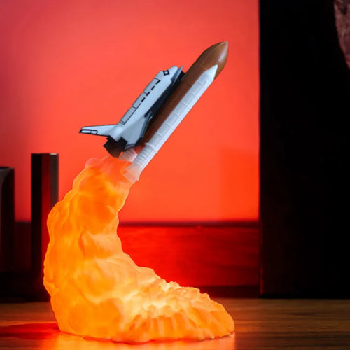 Model of a space shuttle launching from a fiery orange surface with a red background